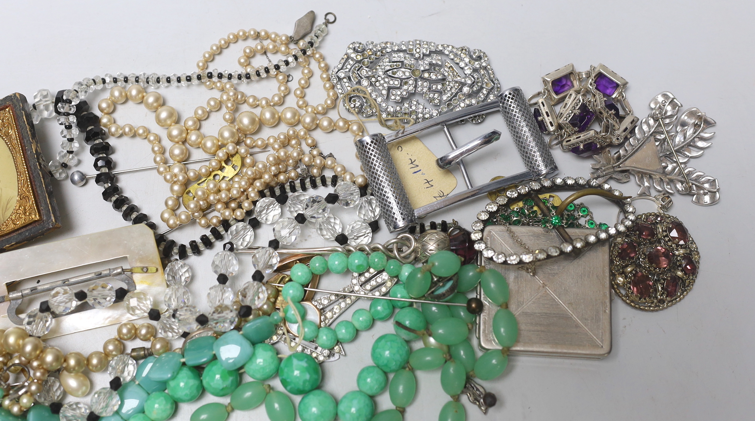 An early 20th century 9ct and gem set 'Suffragette' ring (stones missing) and a group of costume jewellery.